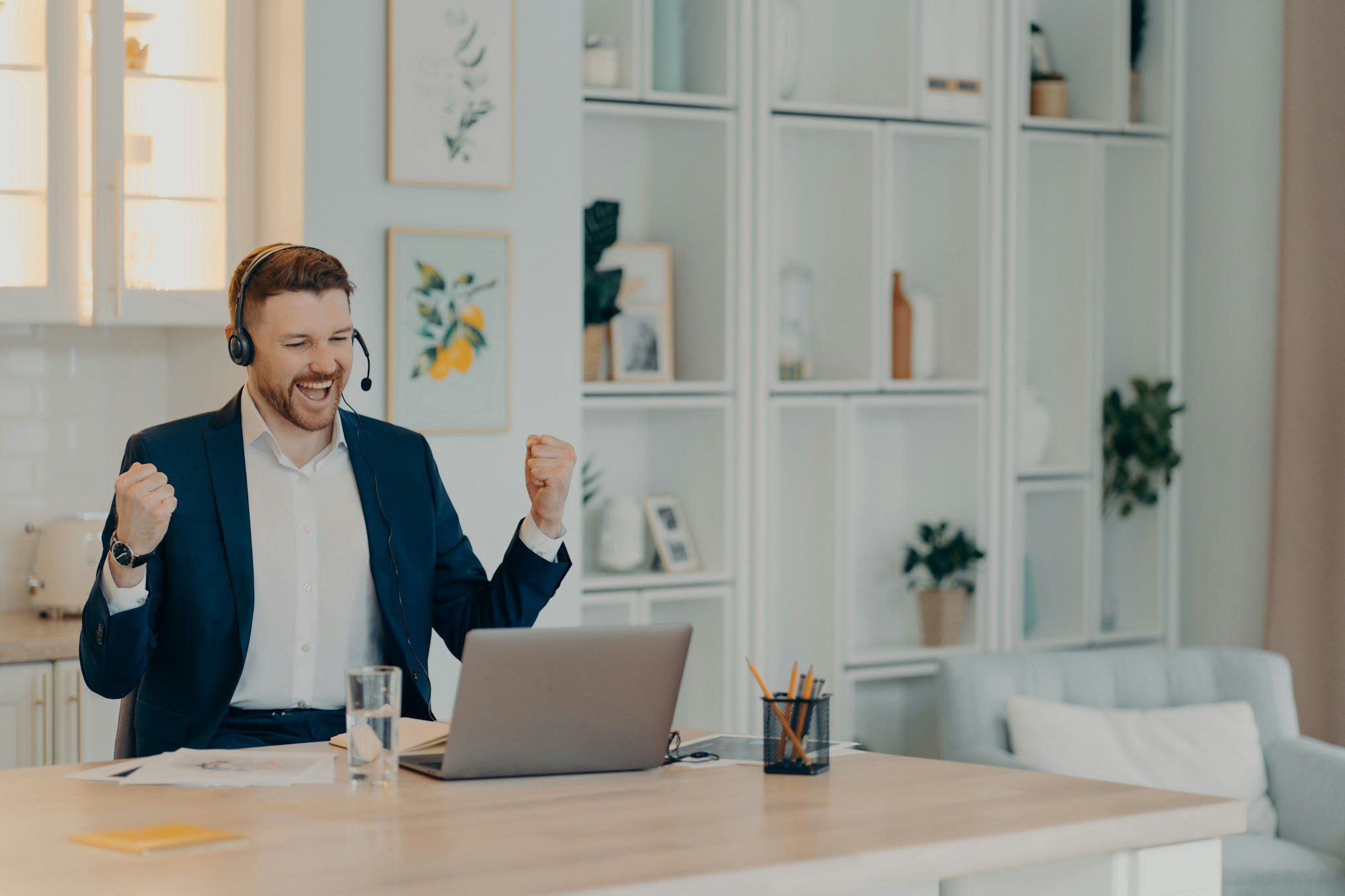 Excited successful businessman enjoying triumph with clenched fists